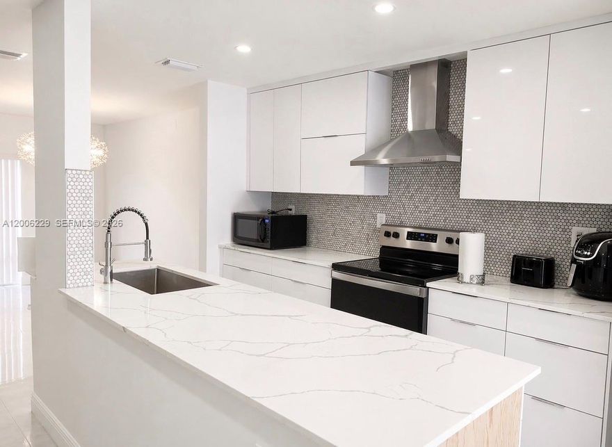 See it, love it and secure it! Purchase this Plantation Florida 3 bedroom, 2.5 bath townhome and enjoy the perfect blend of lifestyle, luxury, excellent schools, parks and the convenience of being in central Broward County. Send me an offer to secure this meticulously updated 3-bedroom, 2.5-bathroom townhome boasting 1,770 sq. ft. of living space and a direct access 1-car garage. This home had no expense spared during renovation. Enjoy the space, feel and scale of a single-family home with the ease of association managed amenities. Walk into this home and you are welcomed to by the reimagined quartz countertops, open concept kitchen, premium stainless steel appliances, and sleek recessed lighting. New flooring throughout, freshly updated bathrooms with contemporary vanities, and a bright, airy open-concept living and dining area. Primary Suite offers a true retreat featuring a gracious walk-in closet and a private balcony—perfect for your morning tea/coffee. Peace of mind comes standard with a new roof, new attic insulation and professional termite treatment. Community & Lifestyle living places you minutes away from the best of Broward County. The Jacaranda community is currently undergoing extensive upgrades, including new fencing, fresh building exteriors, and repaved roads. Includes sparkling pool, tennis courts, picnic, BBQ common areas. This temporary special assessment ensures that when the exterior upgrades are completed, you will be so glad you secured this deal!