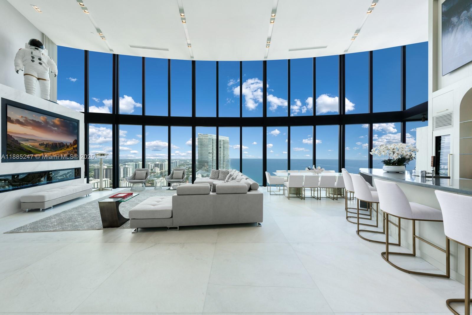Crown Jewel Penthouse at Porsche Design Tower. This 2-level oceanfront residence features soaring 22-ft ceilings, custom wet bar, 98" Sony TV, MiaCucina kitchen with Wolf & Thermador appliances, & a striking Cetta 1800-bottle wine cellar. The primary suite includes Ornare closet, office & gym. Expansive terraces boast a mosaic-tiled pool, fire pit & summer kitchen. Fully Lutron automated Savant, 14 TVs, 3 fireplaces & 4-car sky garage with private elevator. A mansion in the sky, completely reimagined turnkey with exquisite upgrades & flawless finishes. This smart home showcases breathtaking ocean, city & Intracoastal views—set in one of the worlds most exclusive boutique buildings with unmatched privacy & the iconic Dezervator that seamlessly parks you & your car directly inside your home.