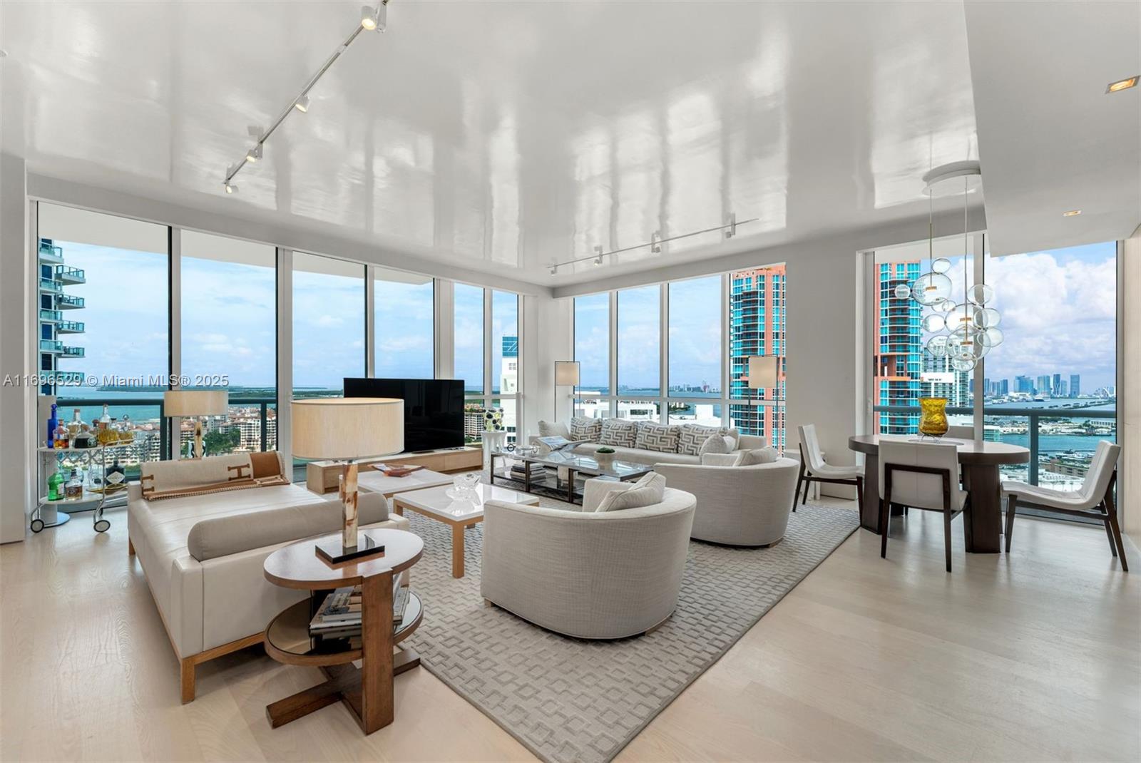 This beautifully renovated three-bedroom residence offers 2,300 SF of refined interior living, complemented by 938 SF of expansive terraces designed for seamless indoor-outdoor living. Enjoy unobstructed views past South Pointe Tower, showcasing the sparkling Miami skyline and breathtaking sunsets—an ideal backdrop for entertaining or relaxing. The interiors are finished with light oak flooring, custom millwork and doors, fully renovated bathrooms and closets, and are elegantly furnished with Holly Hunt and other curated designer pieces, creating a perfect balance of style and comfort.