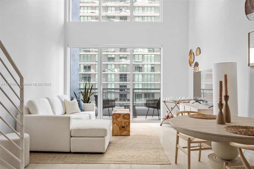 Sleek, two-story loft-style residence soaring above Brickell, offering panoramic views of the city, bay, and ocean. Expansive windows flood the space with natural light, complementing the open-concept design and soaring ceilings. The upper-level suite features a spacious walk-in closet and serene retreat. Modern ceramic floors, in-unit laundry, and impact-resistant doors and windows add comfort and convenience. Enjoy resort-style amenities including a pool, spa, gym with sauna and cold plunge, business center, lounge, and 24-hour doorman. Steps from Brickell City Centre.