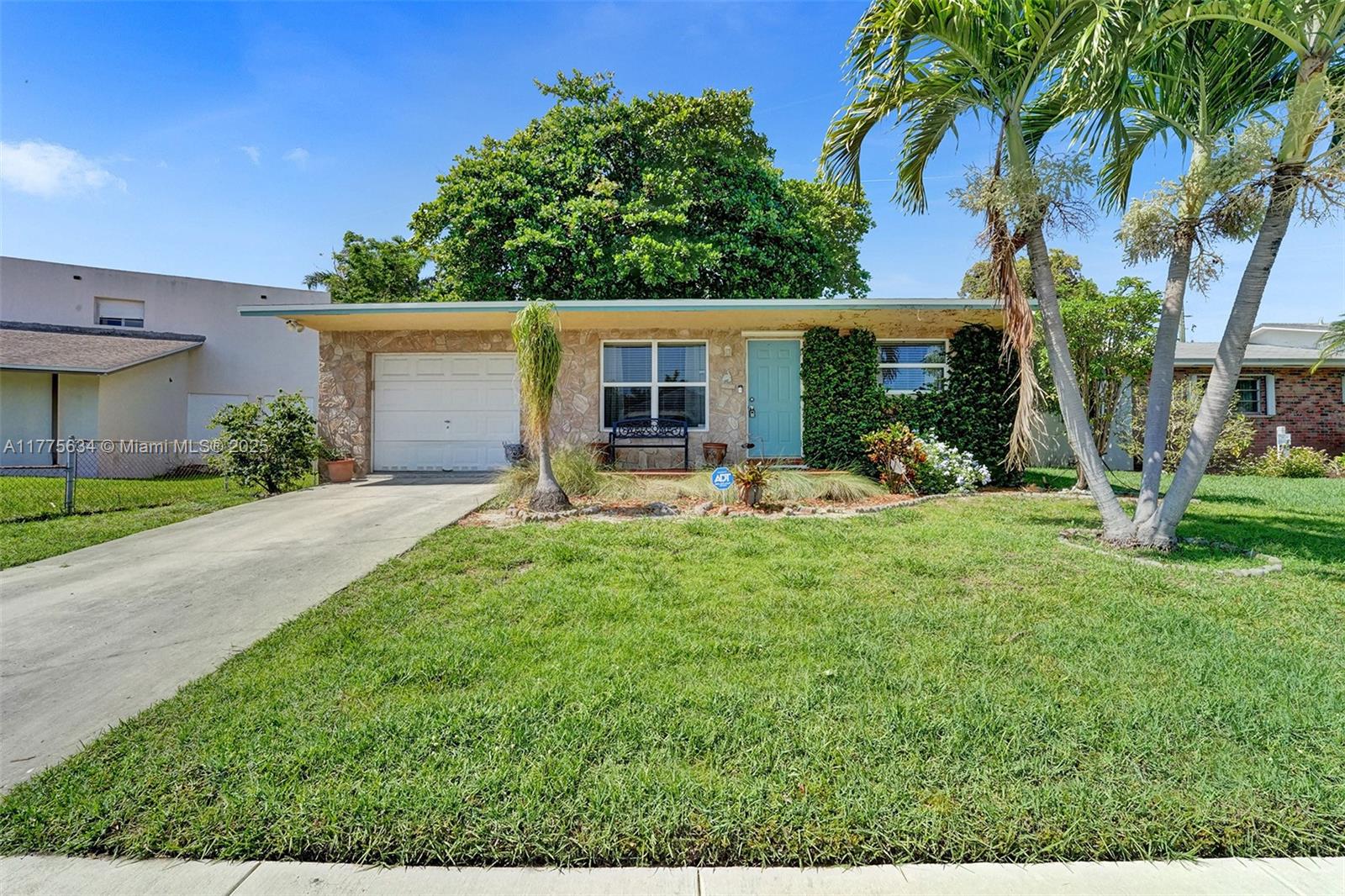This bright and open 3 bed, 2 bath home features full impact windows, including in the garage and utility room. The updated kitchen boasts granite countertops, a spacious eat-in bar, and a seamless flow to the dining area and screened patio—perfect for entertaining. Tile flooring runs throughout the main areas, with cozy carpet in the bedrooms. Additional highlights include a one-car garage with an impact window, a utility room with a full-size washer and dryer, and dual parking in the rear for an RV or extra vehicles. The large yard offers plenty of space to add a pool.