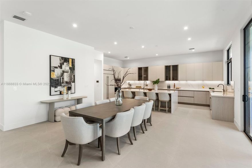 Stunning New Estate in the Gated Community of Pine Rockland Estates with 4,143 SF! Situated on a 14,072 sq. ft. lot, this two-story estate boasts massive entertaining spaces, featuring 4 bedrooms + large den, 3.5 baths, and two 1-car garages. The chef’s kitchen is a showstopper with sleek cabinetry, Wolf/Sub-Zero panel-ready appliances, and a spacious island perfect for entertaining. This home features TWO PRIMARY SUITES one on the first floor and another on the second each designed as a private retreat. The upstairs primary offers a spa-like bathroom with two water closets and two huge walk-in closets. Outdoors, the spacious lot provides plenty of room for a dream backyard oasis whether you’re envisioning a pool, outdoor kitchen, or lush landscaping.