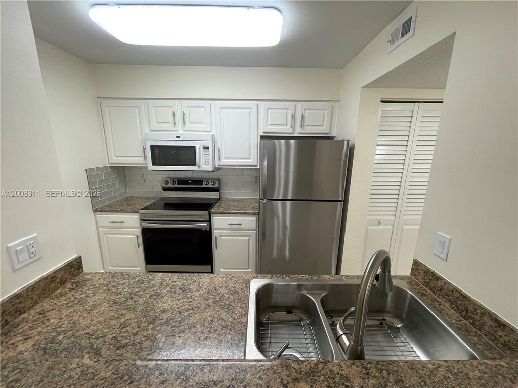 Photo of 2811 N Oakland Forest Dr #102, Oakland Park, FL 33309 (MLS # A12008311)