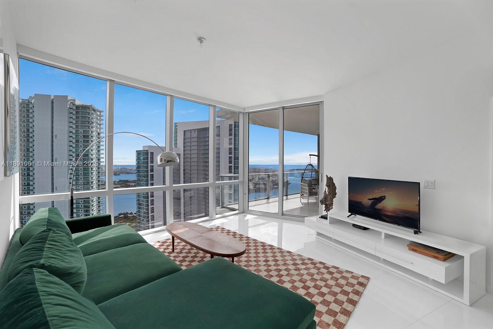 Welcome to Residence 4403 at Paramount Miami Worldcenter, home to Miami’s largest amenity collection. Resort style living on the desirable 44th floor with direct bay views and sunlit interiors framed by floor to ceiling glass. An open floor plan places the kitchen and waterfall edge island facing the living area for effortless entertaining, with a split bedroom layout and a versatile den. Finishes include top of the line appliances, custom built out closets in both bedrooms, and a primary bath with dual vanity sinks, bathtub, and separate shower. A private elevator opens to your own foyer. Additional features include 10 ft ceilings, a bay facing balcony, laundry room, and storage throughout. Premier parking with assigned spaces next to the elevator plus one valet space.