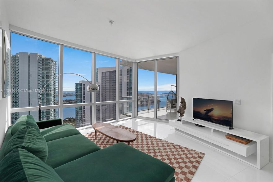 Welcome to Residence 4403 at Paramount Miami Worldcenter, home to Miami’s largest amenity collection. Resort style living on the desirable 44th floor with direct bay views and sunlit interiors framed by floor to ceiling glass. An open floor plan places the kitchen and waterfall edge island facing the living area for effortless entertaining, with a split bedroom layout and a versatile den. Finishes include top of the line appliances, custom built out closets in both bedrooms, and a primary bath with dual vanity sinks, bathtub, and separate shower. A private elevator opens to your own foyer. Additional features include 10 ft ceilings, a bay facing balcony, laundry room, and storage throughout. Premier parking with assigned spaces next to the elevator plus one valet space.