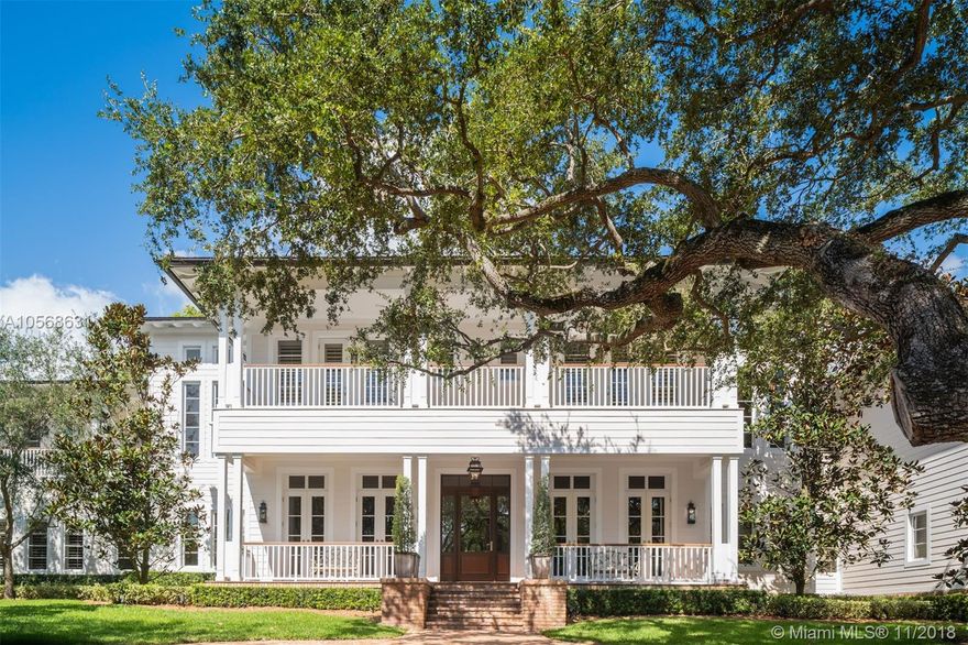 Captivating Plantation-style estate, by renowned architect David Johnson, with the finest modern appointments sitting on a sprawling oak-laden cul-de-sac in Cocoplum Phase 1. Stunning rich wood floors throughout, detailed tongue & groove coffered ceilings, fireplace and built-in bar unites the temperature-controlled wine cellar. The chef-inspired kitchen opens to a large patio w/Summer Kitchen that wraps around the back of the house & overlooks the backyard & swimming pool. First floor has an en-suite guest room, service quarters & powder bathroom. The second floor, accessible also by elevator, has stately Master Suite,3 en-suite bedrooms, add'l family room & a guest suite connected by a covered breezeway. 3-car garage w/height for lifts, if desired. Impact windows & whole-house generator.