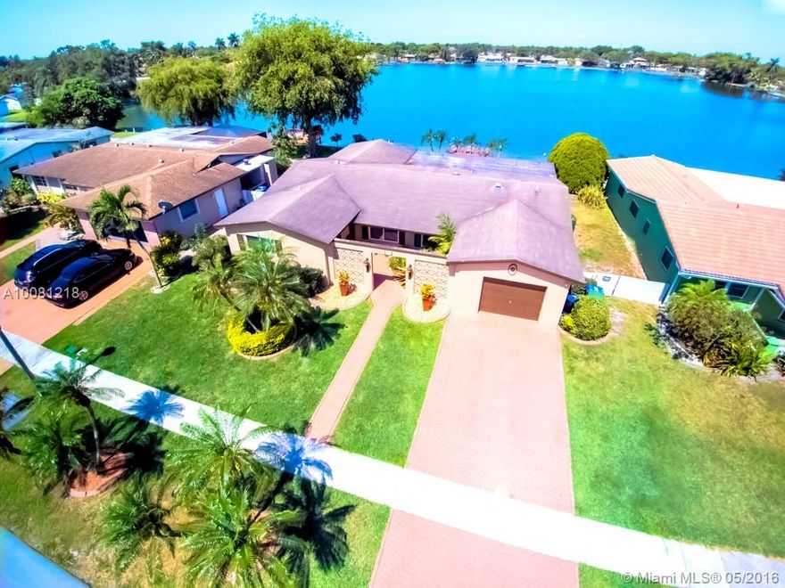 GORGEOUS HOME SITS ON CENTER OF THE LAKE WITH STUNNING VIEWS AND DOCK OVER WATER.  GREAT HOME FOR ENTERTAINING WITH FORMAL LIVING, DINING AND FAMILY ROOMS AND TAKE GUESTS OUTSIDE ON LARGE TILTED COVERED PATIO ON BIG BACKYARD WITH BREATHTAKING VIEW OF THE SUNSET. HOME FEATURES UPGRADED KITCHEN, STAINLESS STEEL APPLIANCES, CROWN MOLDING, NEW IMPACT WINDOWS, TRAVERTINE FLOORING, ELEGANT PAINT AND BEAUTIFUL LANDSCAPING. NO HOA.