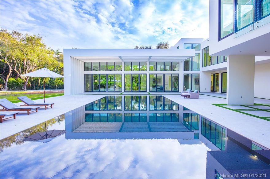 Stunning modern architectural masterpiece designed by Kobi Karp on rare 1.44 acres in Ponce Davis. Built in 2014, this 10,000 SF gated estate blends open concept interiors with sweeping landscape to provide spaces for grand entertaining and intimate family relaxation. You are welcomed into a magnificent great room with soaring 16-foot ceilings and a wall of glass opening on to the breathtaking negative-edge heated pool/expansive terrace. The home features 7 bedrooms including a sumptuous 1,500 SF master suite, 7.5 baths, Mia Cucina kitchen with SubZero/Wolf/Miele appliances, 264-bottle wine cooler, guest house, rooftop terrace, squash court/gym, home theatre, 3-car garage, Lutron/Sonos/URC smart home systems, whole-home generator. An extraordinary achievement of sophistication and privacy.