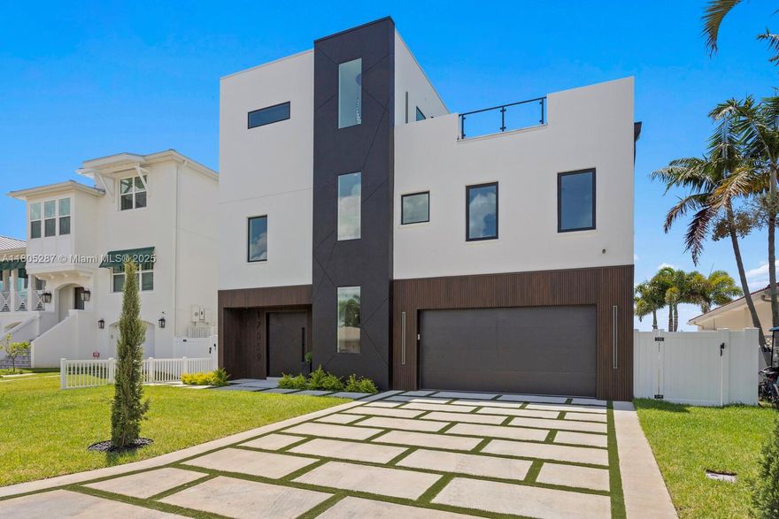 Modern masterpiece by Spinelli Real Estate Development in North Redington Beach, just 1.5 blocks from the Gulf. This 3-story coastal home offers over 1,200 SF of rooftop terrace with beach views and sunsets. Features include a dramatic 20ft chandelier, climate-controlled wine cellar, 9-car garage, and floor-to-ceiling windows. The second floor boasts a chef’s kitchen with quartz island, Thermador appliances, butler’s pantry, and outdoor kitchen. Enjoy 5 bedrooms, a 3-stop elevator, luxe primary suite, rooftop bar, putting green, saltwater pool, 360 spa, and dock on deep water canal.