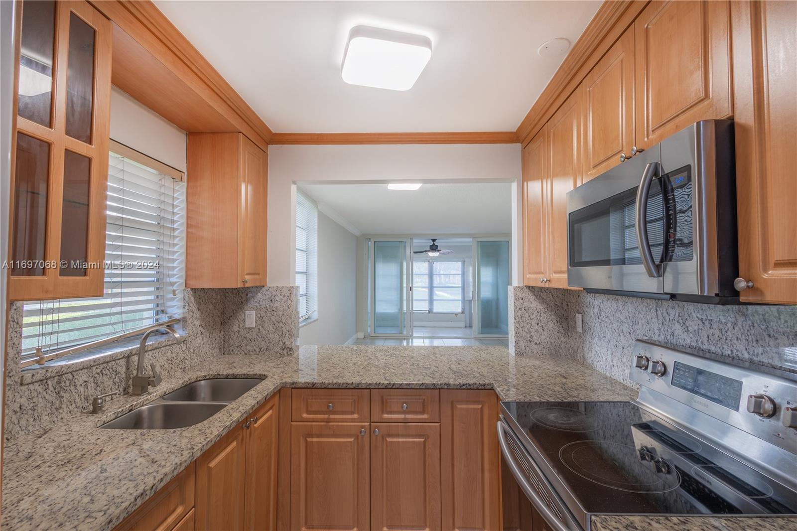 This stunning first-floor corner unit offers extra square footage in the kitchen and additional windows, filling the home with natural light. Featuring 2 bedrooms and 2 bathrooms, this residence is both functional and elegant. The upgraded kitchen is perfect for cooking enthusiasts, while the combination of tile and vinyl flooring ensures low-maintenance living. Relax on your private patio overlooking the serene lake, protected by hurricane-impact patio doors for added safety. 
Bermuda Club is a +55 community with income and credit score requirements.