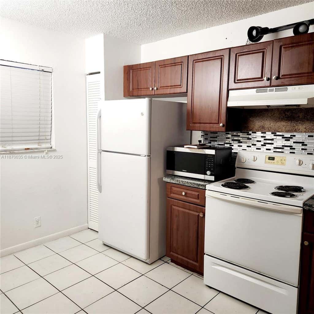 Photo of 9000 NW 28th Dr #1-108, Coral Springs, FL 33065 (MLS # A11870035)