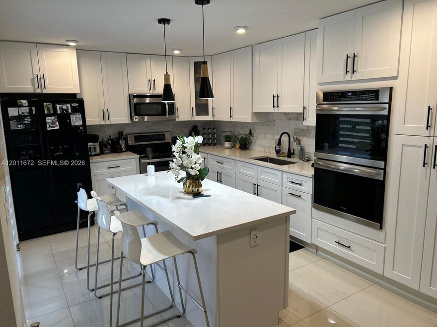 Beautifully kept two-story, 3-bedroom, 2.5-bathroom home in Woodland Lake Estates in Tamarac. The home offers a scenic lake view that can be enjoyed from multiple areas. Updated kitchen with new stainless-steel appliances, along with a washer and dryer and additional storage. Recent renovations include brand new impact windows, new tiles, and retro lights. Bedrooms upstairs include access to a balcony. The primary bedroom features recessed lighting and a private bathroom. Private courtyard provides space for outdoor seating or entertaining. Community offers a clubhouse, pool, and fitness center, with assigned parking and guest parking available. Conveniently located near major highways, including the Florida Turnpike, as well as shopping and everyday essentials.