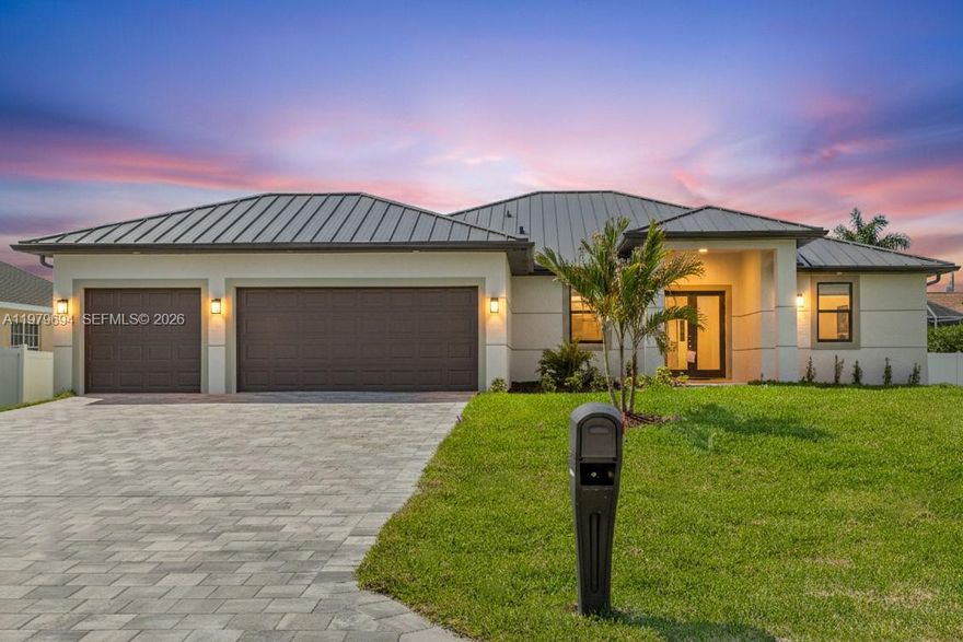 Welcome to a truly exceptional 2026 move-in-ready new construction home with a 2-10 warranty, metal roof, 3-car garage, no HOA, and low estimated insurance costs. Located in NW Cape Coral near Coral Oaks Golf Course and Burnt Store Rd, this contemporary Florida home offers a screened saltwater pool, outdoor kitchen, and a bright open layout with neutral tile flooring. Impact double doors lead to a vaulted living room with sliders to the lanai. The chef’s kitchen features a quartz island, white shaker cabinets, wood-tone accents, black hardware, stainless appliances, and a butler’s pantry with wine fridge. The dining area includes custom cabinetry and a large picture window. The primary suite offers lanai access, a walk-in closet, and a spa-style bath with a glass shower, rainfall head, bench, dual sinks, and quartz counters. A split layout provides a second suite with pool bath plus two guest rooms and a hall bath. The screened lanai showcases the saltwater pool, paver flooring, ceiling fan, and full outdoor kitchen with grill, sink, beverage fridge, granite counters, and modern backsplash. Laundry room, 3-car garage, and durable metal roof complete this stunning home. Experience the best of SWFL living—schedule your private showing and claim your piece of paradise.