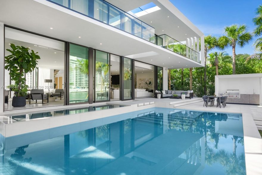 Step Inside With Me! 5777 is the only brand new waterfront home available on the esteemed Pinetree Drive. Designed with modern lines and warmth, the light-filled foyer’s striking 26ft ceilings and floating white oak staircase lead you to a great room for today’s style of living. With water all around, benefit from dual Mia Cucina kitchens, show & chef, featuring Calacatta stone and Miele/Wolf appliances. The 2nd floor, characterized by white oak planks and floor-to-ceiling ESW windows, is home to 6 versatile bedrooms and a media lounge. Entertain on the water by the 37ft long pool, soak in the oversized hot tub, and enjoy a summer kitchen + full cabana bath + new 76’ Seawall. More noteworthy features: chilled wine room, custom bar, elevator, Savant System, 3-car garage and rooftop terrace.