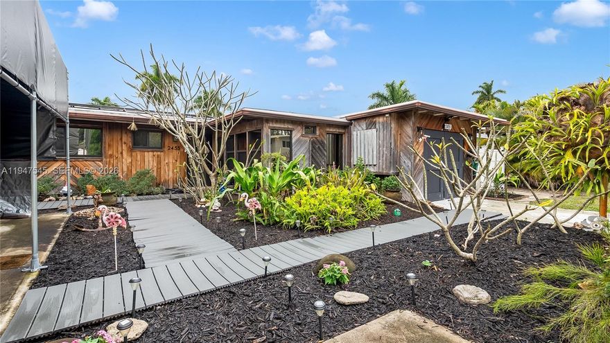 Welcome to this beautifully updated 3-bedroom, 2-bath waterfront home offering direct ocean access with no fixed bridges in the desirable Riverland boating community. Set on a quiet canal with 65 feet of water frontage, the property features a private dock with composite decking, 50-amp shore power, and quick access to the Atlantic Ocean—ideal for boating enthusiasts. The bright, open interior showcases vaulted ceilings with exposed beams and a fireplace in the living room, creating a warm and inviting space for everyday living and entertaining. The renovated kitchen offers white cabinetry, quartz countertops, and a breakfast bar that flows seamlessly into the main living areas. Impact windows and doors add security and energy efficiency. The oversized primary suite is a true retreat, featuring abundant closet space, a private fireplace, and a spacious en-suite bath. Both bathrooms are ready for your final personal touches. Additional upgrades include a 2022 roof and solar panels that help keep monthly power costs low. Outdoor living is designed for relaxation and entertaining with an expansive patio featuring a BBQ area, sink, brick fireplace, hot tub, and serene canal views. Additional highlights include no HOA, a 1-car garage, paver driveways with parking for an RV or boat & access to a nearby community boat ramp. Ideally located just minutes from dining, shopping, beaches, & downtown Fort Lauderdale, this is a rare opportunity to own a true ocean-access waterfront home.