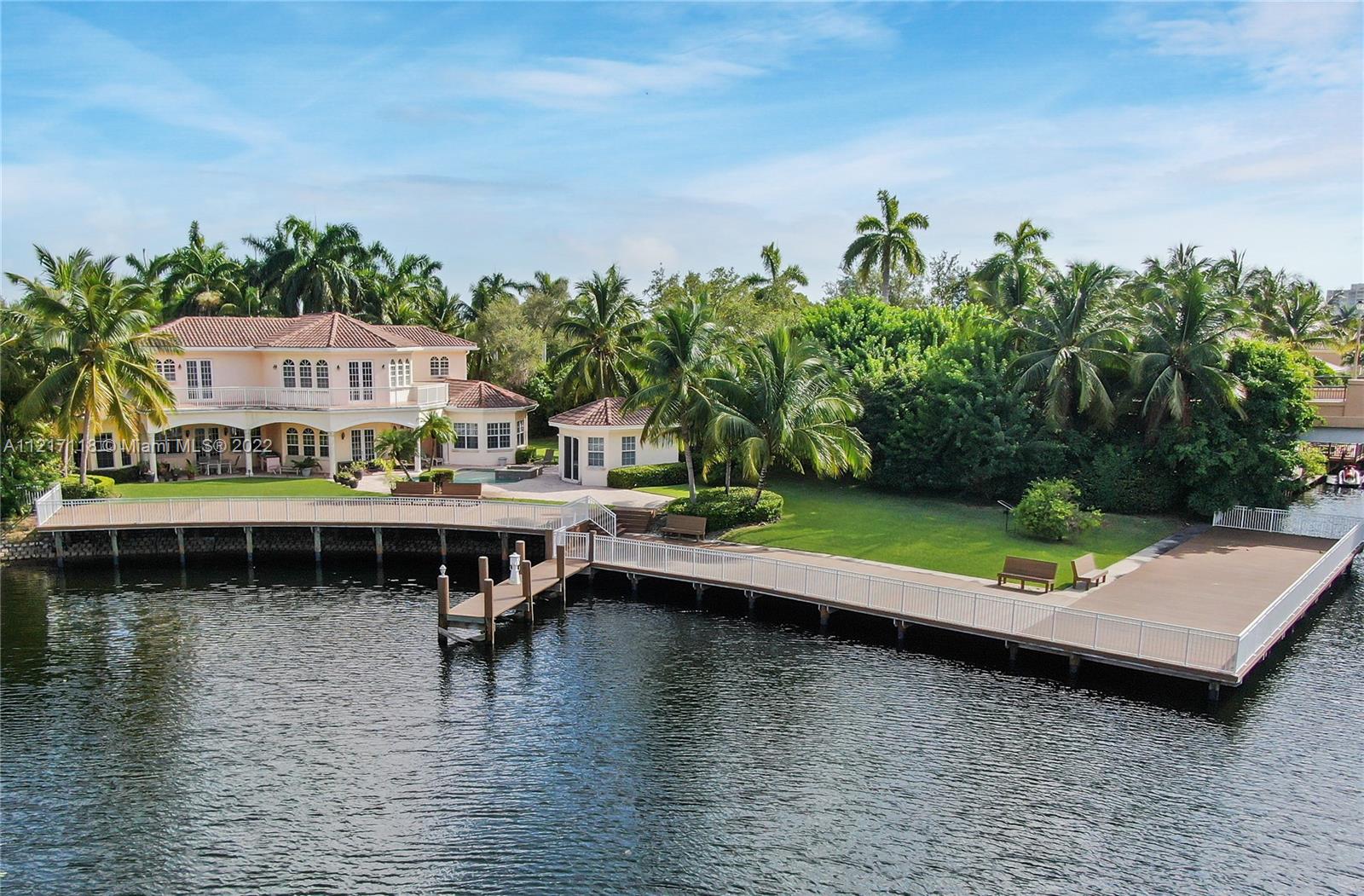 Once-In-A-Lifetime opportunity to acquire the most renowned property in Harbor Islands. Rarely available compound with 6,798 SqFt of living area on a 24,811 SqFt lot. Expansive waterfront living with 235 feet +/- of water and abundant dockage. 4beds/5.5baths & 1bed,1bath detached guesthouse/cabana. 3 car garage. Plenty of green lawn space with fruit trees and open area. Impressive courtyard entrance welcomes a massive floorplan featuring marble floors, large open kitchen, 2 bedrooms on first floor including huge master foyer, 2-story library/office, & wraparound waterfront balcony. New clay tile roof in progress. Private community with multiple security gates, tennis & bball courts, pool, large gym, etc. A true entertainer’s home that will be the landmark among friends and family.