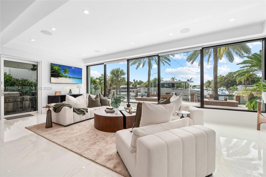 This exceptional waterfront residence is where modern design, thoughtful scale, and a truly rare view come together. Framed by floor to ceiling glass, the home opens to a wide, palm-lined water view that feels more like a private lagoon than a typical waterway delivering sunset views, privacy, and a sense of calm that’s increasingly hard to find.

The interior is airy and refined, with clean architectural lines, warm wood accents, and seamless indoor/outdoor flow. Living spaces are designed for both everyday comfort and elevated entertaining, all oriented toward the water. The kitchen and dining areas connect effortlessly to expansive terraces, creating a natural rhythm between spaces.

Outdoors, a resort-style pool, generous dock, and lush tropical landscaping set the stage for relaxed afternoons and unforgettable evenings. Whether you’re watching boats drift by, hosting friends at sunset, or enjoying the quiet luxury of space and light, this home offers a lifestyle defined by ease, beauty, and perspective.

A contemporary waterfront home with a view that stands in a class of its own.