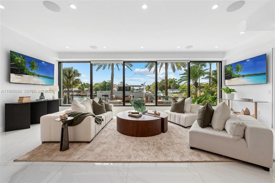 This exceptional waterfront residence is where modern design, thoughtful scale, and a truly rare view come together. Framed by floor to ceiling glass, the home opens to a wide, palm-lined water view that feels more like a private lagoon than a typical waterway delivering sunset views, privacy, and a sense of calm that’s increasingly hard to find.

The interior is airy and refined, with clean architectural lines, warm wood accents, and seamless indoor/outdoor flow. Living spaces are designed for both everyday comfort and elevated entertaining, all oriented toward the water. The kitchen and dining areas connect effortlessly to expansive terraces, creating a natural rhythm between spaces.

Outdoors, a resort-style pool, generous dock, and lush tropical landscaping set the stage for relaxed afternoons and unforgettable evenings. Whether you’re watching boats drift by, hosting friends at sunset, or enjoying the quiet luxury of space and light, this home offers a lifestyle defined by ease, beauty, and perspective.

A contemporary waterfront home with a view that stands in a class of its own.