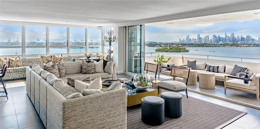 Indulge in luxury w/ this meticulously renovated 4BD/3.5BA corner unit, a seamless fusion of sophistication & comfort. Revel in breathtaking views stretching from SoBe to the Miami Skyline. The expansive living room boasts custom furnishings, open kitchen w/ample eat-in area, black & white marble countertops, wine cooler, beverage fridge, & custom cabinetry. The primary BD offers custom closets w/built-ins, an oversized bathroom w/ dual sinks, & spa shower. Grey porcelain tile floors, impact windows w/ remote shades, separate laundry room, plus 2 covered parking spaces. Soak in the breeze & mesmerizing views on your oversized covered balcony. Valet parking, 24-hr security, pool, gym, & boat slips, this full-service building epitomizes Miami Beach living at its finest.
