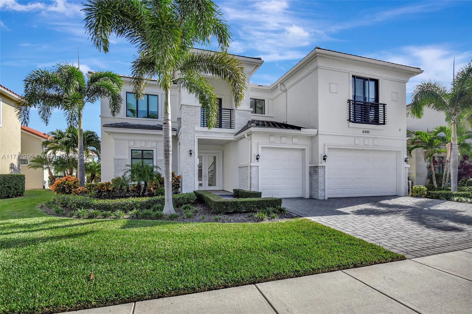 This contemporary residence at the Royal Palm Polo Club features five bedrooms, five and a half baths, a loft plus den/office, and a three-car garage. It offers a 24-hour manned gate, a clubhouse with a resort-style pool, cabanas, gym, playground, tennis & pickleball courts. The kitchen includes Sub-Zero and Wolf appliances, large island, gas water heater, and a gas range. The premier home site boasts a pool & spa with a lake view. The first floor offers stunning 12 to 24-foot ceilings and a double-story grand room for entertaining. The master bedroom suite on the first floor provides privacy and direct pool access with his and hers master bathrooms. First floor also has a guest en-suite, powder room and a den/office/playroom. The second floor has three bedrooms, two bathrooms and a loft.