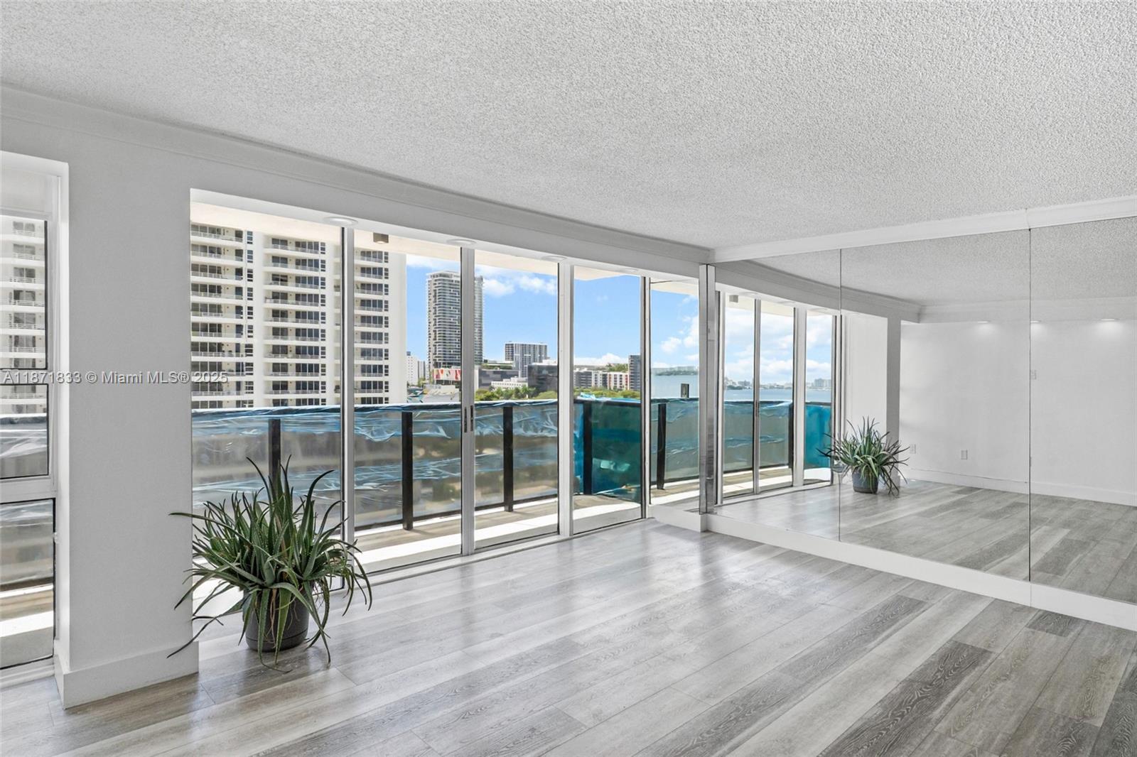 Discover this beautiful and spacious 2-bedroom/2-bathroom condo, offering magnificent bay views. The unit features floor-to-ceiling windows that flood the space with natural light, along with tile floors throughout. The open-style kitchen and in-unit laundry room with a full-size washer and dryer add convenience. The condo comes with assigned parking and ample guest parking, and internet and cable are included in the maintenance fee. Enjoy a true resort-style living experience. The building offers a heated pool, gym, BBQ area, tennis courts, basketball and handball courts, a jacuzzi, a party room, a deli, a convenience store, dry cleaners, a coffee shop, a hair salon, and 24-hour security. Guest parking is free. An ideal location within walking distance of the Design District and Midtown.