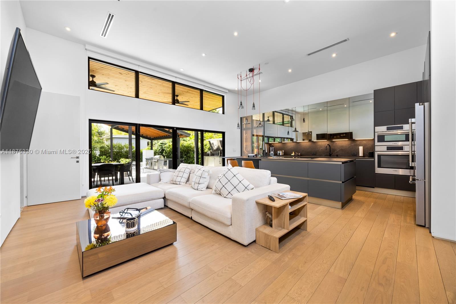 Sleek & Elegant 3/3 modern pool residence on an oversized lot, transformed in 2023 with a new expansion, roof, plumbing, electrical, AC, and Jandy pool system. The backyard is your private tropical oasis featuring a sparkling 15’x30’ pool, perfect for relaxing or entertaining. Inside, a light-filled open floor plan showcases a chef-inspired Italian kitchen with Bosch appliances, Dekton countertops, and a 42-bottle wine cooler. The luxurious master suite offers a spa-like bath with oversized soaking tub and shower. Designer touches include Spain wood floors, Italian doors, vanities, and dramatic 12.5-ft ceilings. A true modern retreat combining style, comfort, and sophistication. Seller offering $20,000 toward buyer closing costs!