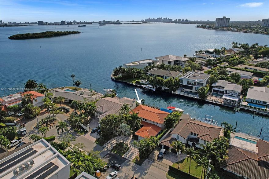 Located in the gated, police-protected community of Sans Souci Estates, this 2-story concrete home offers breathtaking open bay views and an extra-wide deep-water canal with ocean access just minutes away. Perfect for larger boats, it features a 20,000-lb boat lift and a sprawling outdoor entertaining area with a pool, lush landscaping, and up-lighting. Inside, enjoy 5BR/4BA, soaring ceilings, marble floors, and natural light throughout. The oversized master suite boasts one of the largest layouts in the area, a spa-like bath, and a huge private terrace overlooking the bay. The air-conditioned 2-car garage doubles as flexible space. This premium property shines day and night, offering luxury waterfront living at its finest.