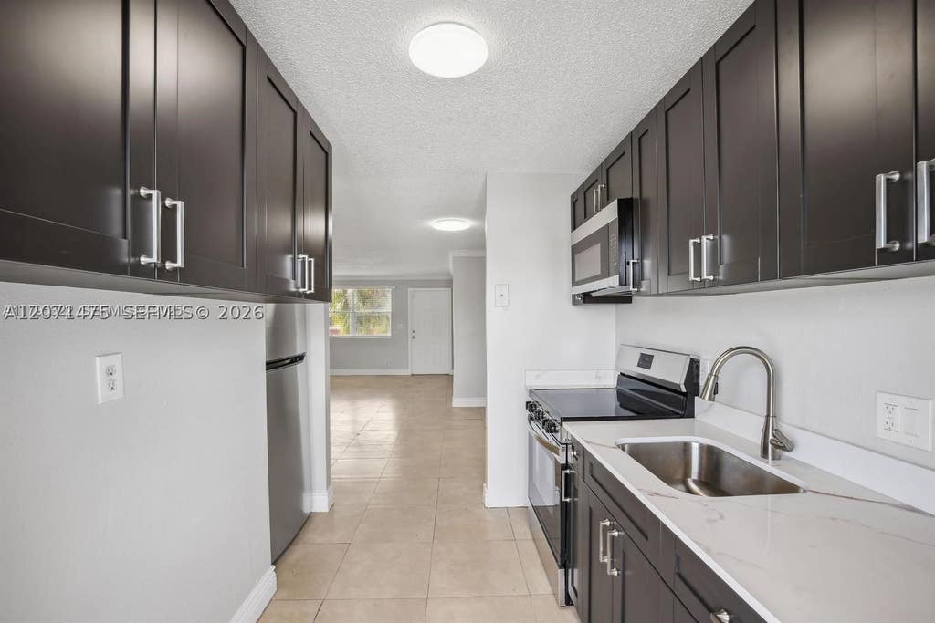 Photo of 850 E Commercial Blvd #214B, Oakland Park, FL 33334 (MLS # A12071475)