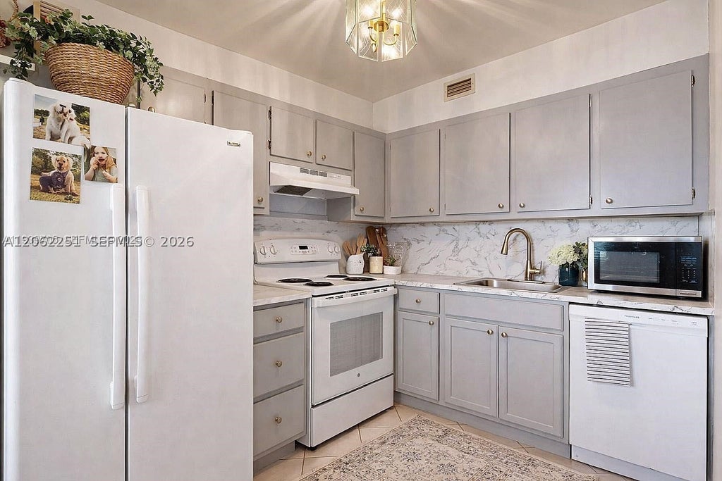 Photo of 13450 SW 3rd St #408D, Pembroke Pines, FL 33027 (MLS # A12062251)