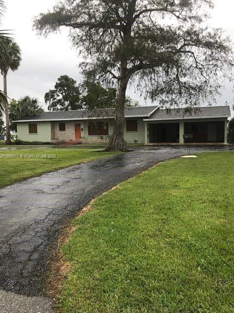 Welcome to 1376 E Main St, a beautifully maintained 3BR/2.5BA home in the heart of Pahokee, offering over 1,500?sq?ft of living space on a generous .35-acre lot. Step inside to find hardwood floors, a formal dining room, a dedicated den/office room, and abundant storage including attic and workshop space. The functional layout includes a dedicated inside laundry room with half-bath accessed via the garage. Sliding glass doors open to a serene backyard, and the property is complemented by an attached double carport, 2-car garage, circular driveway, and even a well. A perfect blend of style, size, and smart design in a quaint South Florida town less than 10 minutes from Lake Okeechobee. Strong equity position and immediate move-in ready.