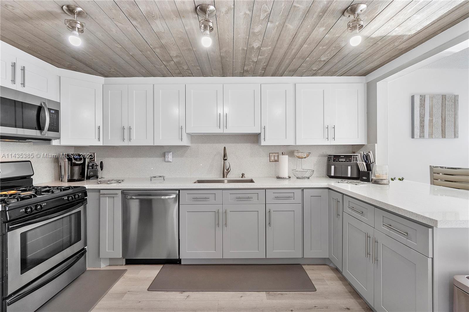 Incredible opportunity to own a spacious 2-bedroom, 2 ½- bathroom corner-unit townhome in Snapper Village. The renovated kitchen includes newer stainless-steel appliances, quartz countertops and backsplash and a gas stove. All three bathrooms have been completely renovated bringing them to modern standards. Downstairs and stairway flooring have been completely replaced with high-end, waterproof laminate. Newer a/c and new washer and dryer. Spacious corner wrap-around patio with storage unit. Exterior renovations and 40-year certification have been completed on this building. Amenities include pool, tennis court, walking path, community room and more. Centrally located near Baptist Hospital, Publix, Fresca, and Turnpike, Snapper Village is an excellent community to live or invest in!