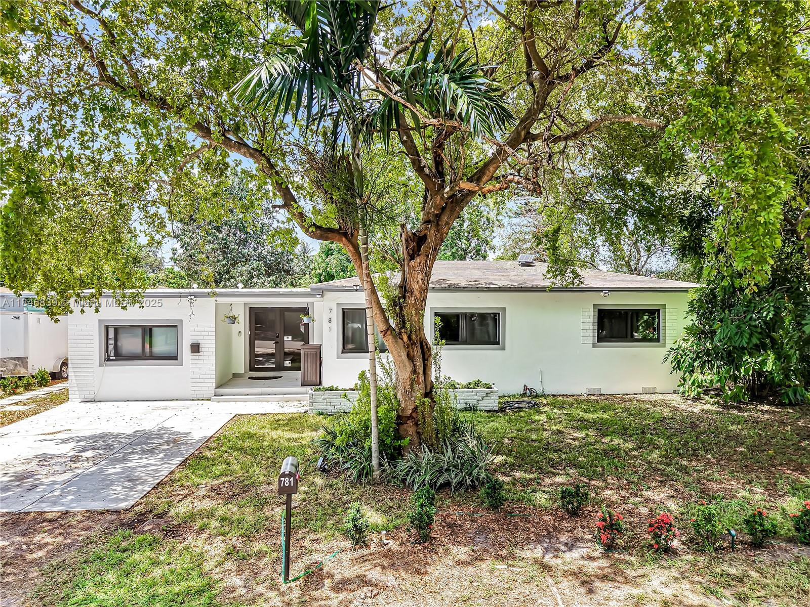 Welcome to this stunning 4-bedroom, 3-bath home on an oversized corner lot in desirable North Miami Beach. This home offers two primary bedroom suites with private baths, including one with its own entrance—perfect for an in-law suite, guest quarters, or potential rental income. The open layout includes a modern eat in kitchen with quartz counters and stainless-steel appliances. Recent upgrades feature a new electrical panel and wiring, automated LED lighting, remodeled baths with PVC plumbing, impact windows and doors, and vinyl flooring with tile in baths. The fenced backyard is great for relaxing, entertaining, or adding a pool. Close to beaches, highways, dining, downtown Miami and Ft. Lauderdale. No HOA. This move-in-ready home blends style and function with attention to every detail.
