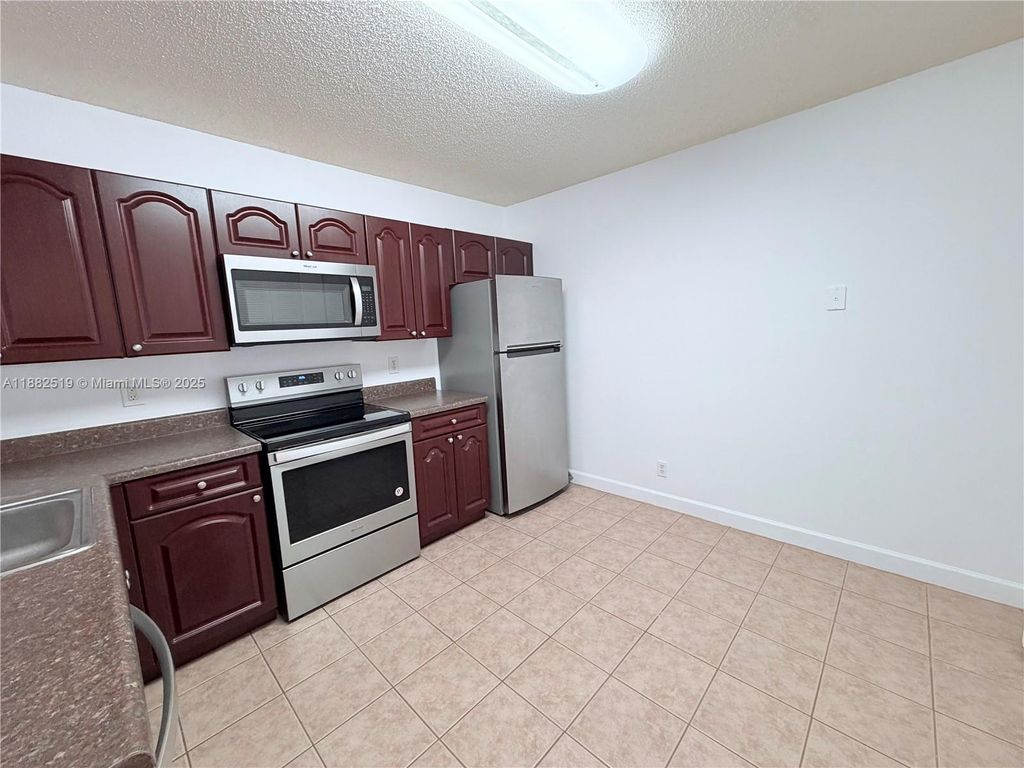 Photo of 5761 Riverside Dr #303B4, Coral Springs, FL 33067 (MLS # A11882519)