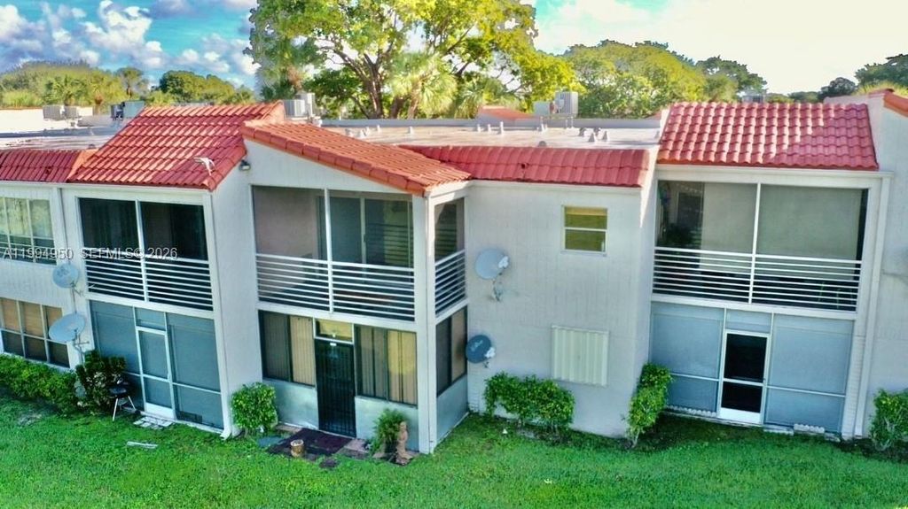 Photo of 7435 Woodmont Ter #202, Tamarac, FL 33321 (MLS # A11994950)