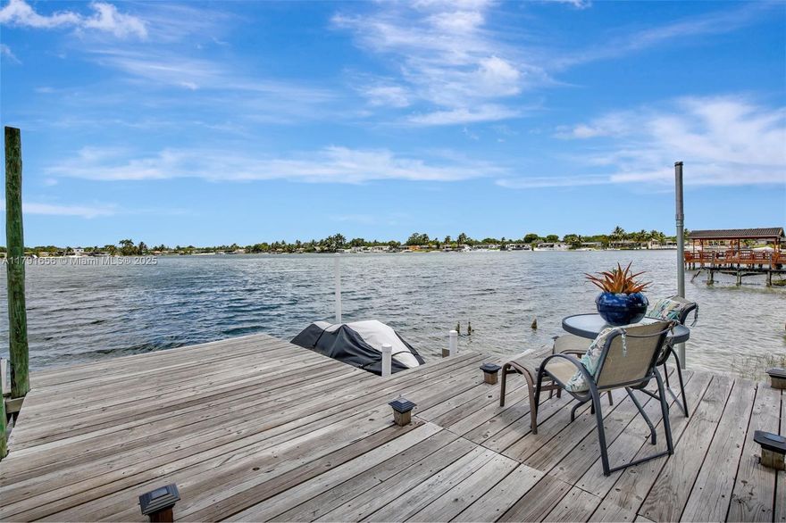 Breath taking lake front views! Beautiful 3 bedroom, 2 bathroom home with potential for additional rooms/space. 2,600 sqft of living space and one of the biggest lots at 10,125 sqft. This home is well maintained. Kitchen and vinyl floors remodeled 2020, Metal roof 2020, master bath tiles, light fixtures, and vanity 2025. AC 2014. Amazing dock with tiki hut, sandy beach area, and fire pit area. Has a private boat ramp, jetski floating dock, and boat lift. Enjoy jet skiing or boating on all three lakes. This neighborhood is a gem hosting motorized lakes which are rare in Miami-Dade County. Amazing schools and parks nearby. Close to I-75 and FL Turnpike. Make this home yours to have fun filled weekends on the water and build long-lasting memories.