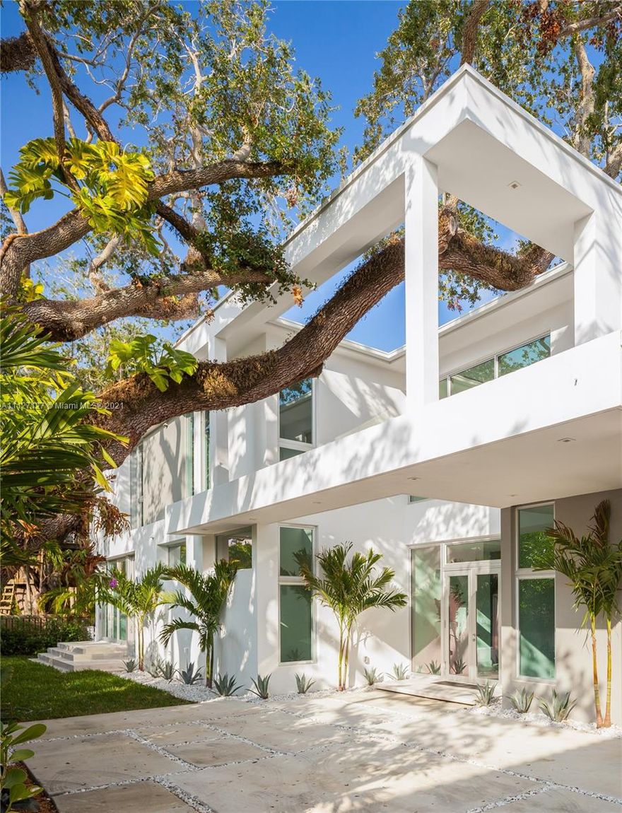 Built in 2018, this stunning modern home redefines luxury living tucked away on a secluded North Coconut Grove oasis. The home features 6 bedrooms, 5.5 bathrooms on two levels of 5,410 sf with soaring double-height ceilings, abundant natural light and modern finishes situated on a 9,600 sf lot. The kitchen is designed by MiaCucina and features Subzero and Wolf appliances, a 120 bottle wine cooler, induction cooktop, steam oven and quartz / natural wood counters. The master suite is curated with luxury fixtures, a MiaCucina walk-in closet, a spectacular steam shower and a soaking tub with commanding views of the lush and mature landscaping. Outside, this private, gated property has a heated swimming pool, turf lawn and covered entertaining patio with a custom Argentine grill.