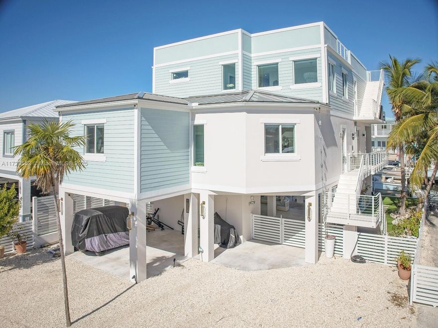 PARADISE! Why dream about it when you can live it! This waterfront beauty, custom-built in 2023 has it ALL! 3,362 SF under A/C plus over 4,000 SF of outdoor living space. 4 Bedrooms & 4 Bathrooms! Ground floor is a wide open covered outdoor space overlooking pool & water. 2nd floor has a lg. custom kitchen with top of the line appliances, open living space along w/2 bedrooms & 2 bathrooms. 3rd floor feat. a lg. primary suite w/a spa-inspired bathroom, a wet bar & balcony overlooking the pool & water. Also on 3rd floor, the 4th bedroom/bathroom & a lg. laundry room. The rooftop deck has 1,562 SF of endless Bay views! Some of the many features are: elevator, 1,000-gallon propane tank, electric car charger,  two 50-amp outlets, 4-pole boat lift & MUCH more. Only seconds away from open waters!