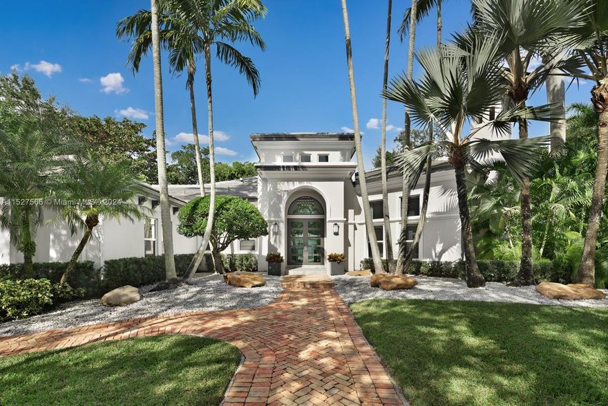Magnificent One-Story Residence in the heart of Pinecrest. A sprawling 34,891 SF lot enveloped by mature landscaping for ultimate serenity and privacy. An exquisite floor plan comprising of 5 bedrooms, 4 full & 2 half bathrooms. Immerse yourself in the grandeur of voluminous ceilings and porcelain tile wood floors adorning the entire home, which include a gracious living room, formal dining area, and a family room. The gourmet chef's eat-in kitchen is outfitted with top-of-the-line appliances and offers views of pool and screened-in patio. The opulent primary suite features an expansive walk-in closet and luxurious spa bath. Additional amenities include impact glass doors/windows, a covered terrace, pool, and a 2-car garage, ensuring a lifestyle of utmost sophistication and convenience.