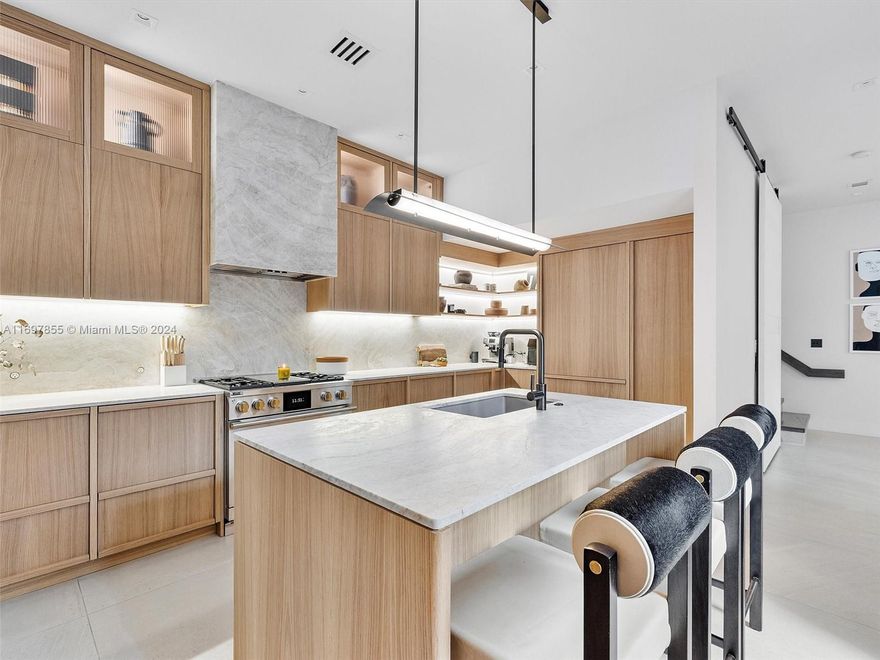 One-of-a-kind luxury Townhome. Don't miss a chance to live in this turnkey residence, designed by IG Workshop, with unmatched upgrades in one of the most coveted floorplans. Featuring a Selezioni Italian kitchen with leathered Taj Mahal quartzite countertops and refined details like British switches. The living room offers custom-built shelving, a dining room that opens to a private alfresco area. Upstairs, enjoy three en-suite bedrooms, a playroom, and a guest suite with private entry. The third floor’s primary suite includes dual closets, a landscaped terrace, and a spa-like bathroom with Grigio Montes marble. The top floor offers a flexible office or bedroom with a second private terrace. Aqua’s premier amenities include two waterfront pools, a state-of-the-art gym, club room and more.