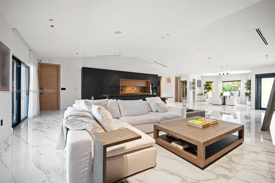 Step into this meticulously renovated residence in the Western Gate of Eastern Shores, an enclave of single-family waterfront homes.
This 5-bedroom EACH W/ EN-SUITE BATH, plus cabana is
Introduced by a DRAMATIC PIVOT ENTRY DOOR with switchable privacy glass,
The chef kitchen is outfitted with premium MIELE appliances, induction cooktop, and fully integrated cabinetry-clad appliances. The island features waterfall leathered countertop finish and double-sided cabinetry.
Smart, sophisticated, and detail driven, the home includes customized closets with integrated motion sensored lighting, motorized window treatments, Sonos Sound System, and a SPA INSPIRED primary suite with Dual closets and bathrooms, featuring separate STEAM SHOWER, JACUZZI TUB + 2 smart toilets. A flexible multi-space 2 car garage with a/c split.
Enjoy expansive waterfront living designed for entertaining and relaxation with Summer Kitchen, Shore Power, no fixed bridges, fast ocean access, and 85’ of waterfront.  Ideally positioned moments from Uptown Harbour, a transformative waterfront destination set to elevate the area with green space, marina, dining and retail, and more.