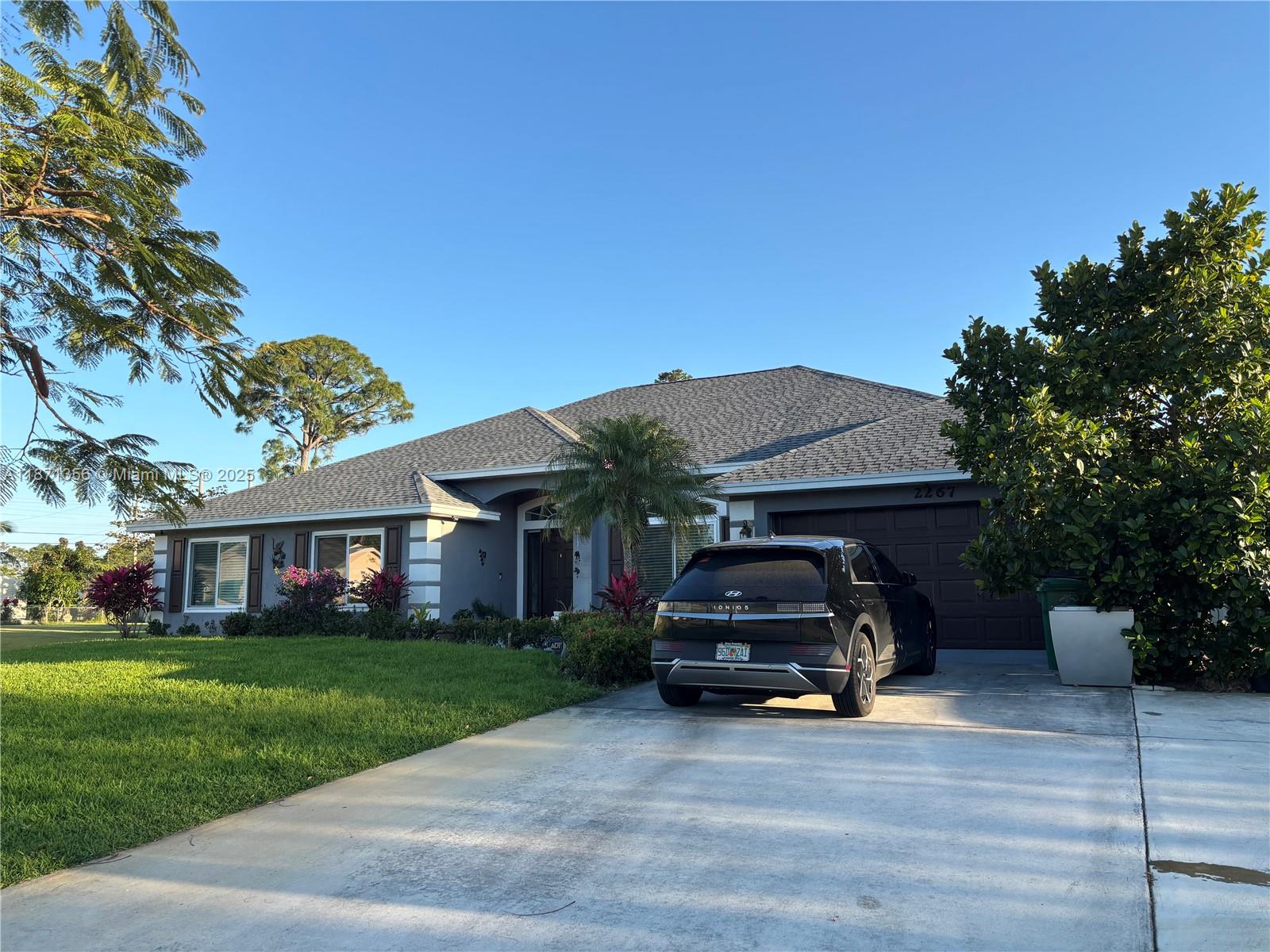 LOCATION! LOCATION!COME AND FALL IN LOVE WITH THIS HUGE OPEN FLOOR PLAN HOME IN PORT SAINT LUCIE, HUGE MASTER SUITE WITH TUB AND SHOWER, A GRAND KITCHEN WITH LOADS OF CABINETS A PANTRY, GRANITE COUNTER TOP, HURRICANE IMPACT WINDOWS AND DOORS, FAIRLY NEW ROOF, COVERED SCREENED LANAI, OVERZIED PIE SHAPED LOT WITH FRUIT TREES; JACKFRUIT TREE, JUNE PLUM TREES, SWEET AND SOURSOP TREES, ADVACADO TREES APPLE TREE, COCONUT TREES, PAPAYA TREES PLANTIAN AND BANANA TREES AND MUCH MORE. 5 MINUTES FROM LOVELY TRADITION AREA, WITH HOSPITAL, MEDICAL CENTERS, SUPERMARKETS TO INCLUDE; PUBLIX, ALDIS AND WALMART. AROUND THE CORNER FROM STARBUCKS AND MINUTES FROM HOME DEPOT, MILLER STEAKHOUSE AND PLENTY MORE RESTAURANTS, AT THE GATLIN BLVD I95 EXIT...