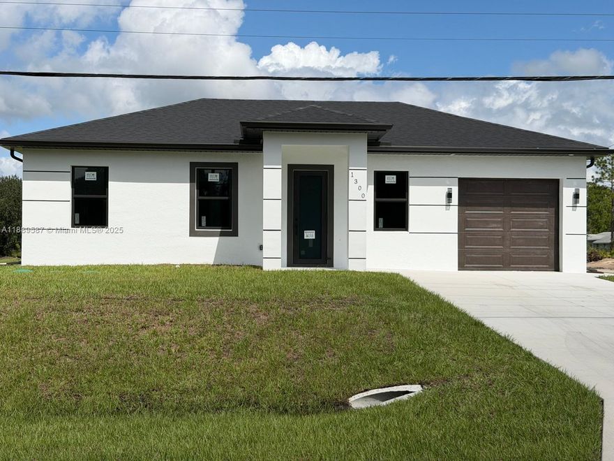 New Construction Home! This modern 3 bedroom, 2 bathroom home with a 2-car garage is located at 1300 W 10th St, Lehigh Acres, FL 33972. Featuring an open floor plan, high ceilings, and sleek finishes throughout, the home offers a stunning kitchen with quartz countertops, waterfall island, stainless steel appliances, and modern fixtures. The split-bedroom layout provides privacy, while large windows bring in plenty of natural light. With its contemporary design, spacious garage, and convenient location near schools, shopping, and main roads, this home is move-in ready and perfect for today’s lifestyle.