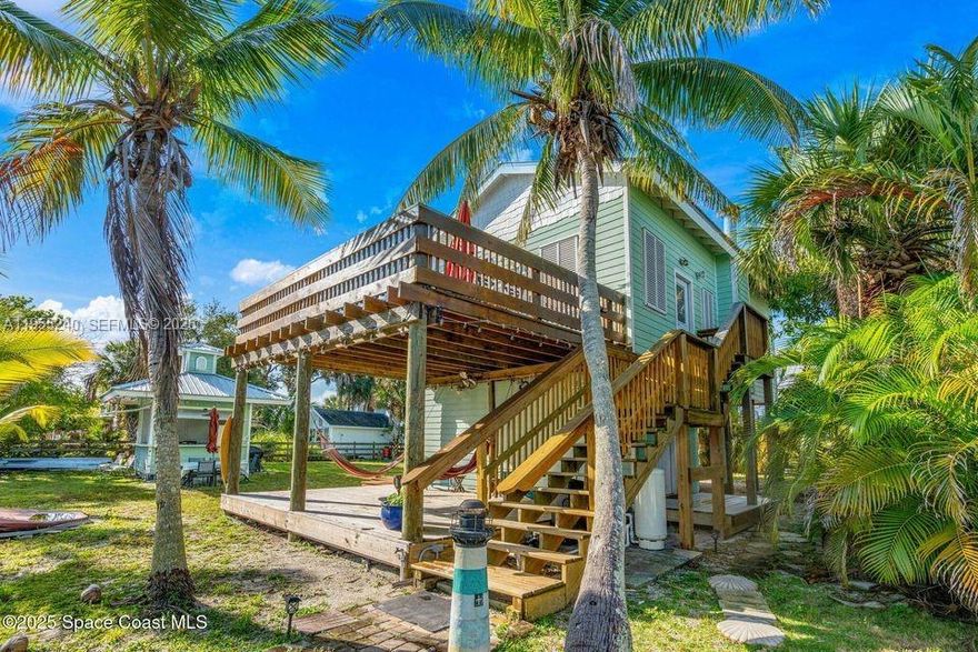 Escape to VIP Island, a one-of-a-kind waterfront community only accessible by boat! This two-story island retreat sits on a double lot with 100 feet of water frontage, private dock, and seawall, ideal for fishing, kayaking, or watching dolphins glide by. Relax in your hammock on the large, covered patio or enjoy sunrise and rocket launches from the upstairs balcony. The home offers a private guest suite downstairs with full bath, and upstairs an open kitchen, dining, and living area with vaulted ceilings, two bedrooms, a full bath, and a spacious loft with endless possibilities. Entertain under the outdoor gazebo or plan your future resort-style pool with room to spare. Just 5 miles south to ocean access through Sebastian Inlet and 15 minutes by boat to an uncrowded beach. Whether a weekend escape or full-time home, this is Florida island living made simple. Schedule your private island tour today!