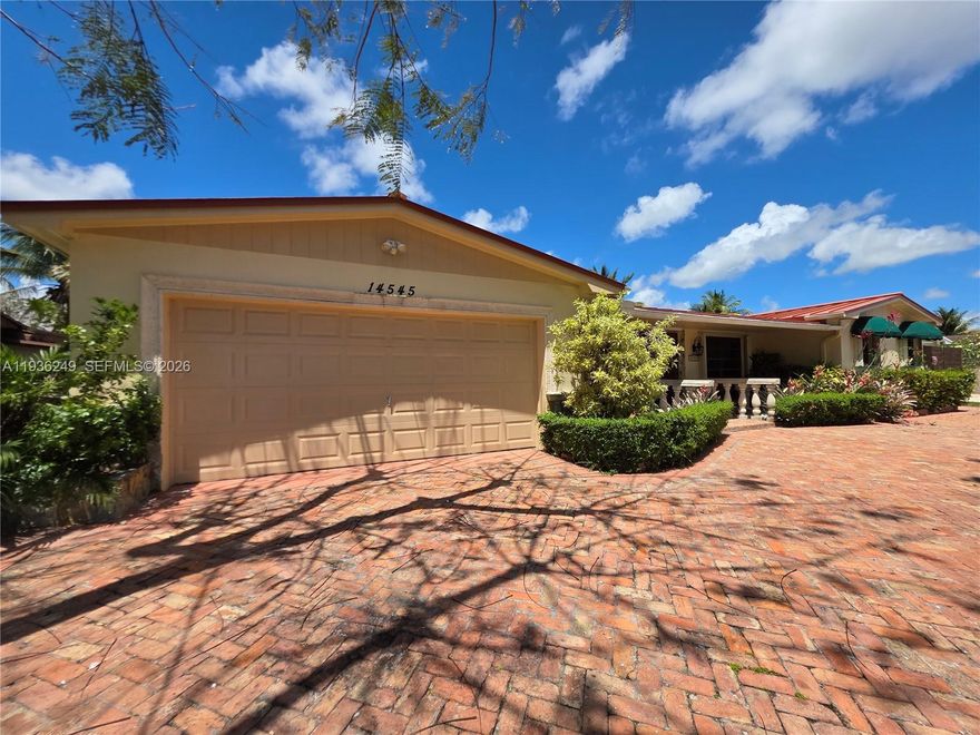 Welcome to this beautifully maintained 1974 waterfront home located in the highly desirable and quiet community of Kendale Lakes. This spacious residence offers breathtaking lakefront views and a seamless indoor–outdoor lifestyle, perfect for both relaxing and entertaining. The home features a large, open kitchen and an expansive family room filled with natural light and stunning views of the water. Sliding doors throughout the living areas open completely to the oversized deck, allowing you to effortlessly blend indoor and outdoor living—ideal for gatherings, entertaining, or enjoying peaceful sunsets by the lake.   Surrounded by lush landscaping, the property offers privacy and a serene atmosphere rarely found. A circular driveway provides ample parking and adds to the home’s impressive curb appeal. With generous living spaces, tranquil lake views, and a prime location in a quiet neighborhood, this home is a rare opportunity to enjoy Florida living at its finest. ALARM AND SURVEILLANCE CAMARAS AT PREMISES