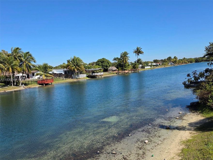 Welcome to this beautifully maintained 1974 waterfront home located in the highly desirable and quiet community of Kendale Lakes. This spacious residence offers breathtaking lakefront views and a seamless indoor–outdoor lifestyle, perfect for both relaxing and entertaining. The home features a large, open kitchen and an expansive family room filled with natural light and stunning views of the water. Sliding doors throughout the living areas open completely to the oversized deck, allowing you to effortlessly blend indoor and outdoor living—ideal for gatherings, entertaining, or enjoying peaceful sunsets by the lake.   Surrounded by lush landscaping, the property offers privacy and a serene atmosphere rarely found. A circular driveway provides ample parking and adds to the home’s impressive curb appeal. With generous living spaces, tranquil lake views, and a prime location in a quiet neighborhood, this home is a rare opportunity to enjoy Florida living at its finest. ALARM AND SURVEILLANCE CAMARAS AT PREMISES