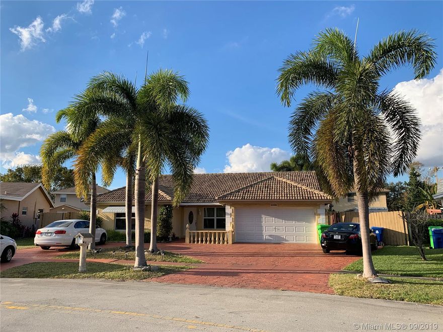 Completely renovated, Marble, wood and title floors, upgraded kitchen with stainless steel appliances. Bathrooms with granite counter tops and wood cabinets and W/D include.  Frame-less shower in master bathroom and Jacuzzi tub in guest bathroom. Outside built-in kitchen in the titled screen room. Extra den in Kitchen area. Title roof keep the house much cooler and energy efficiency. All impact glass windows and impact glass sliding door make the house meets insurance enforced wind code. New reinforced garage door approx. 4 yrs old. Shutter for front door and rear doors. Nice and wide circular concrete driveway for extra parking. Fenced yard with vehicle access on both sides for boat, RV or car storage. Fresh paint interior./exterior. AC 3 yr old. Two extra rooms for storage 2nd floor.