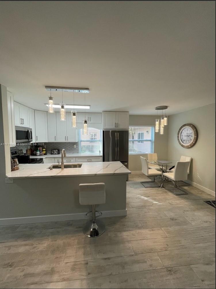 Welcome to Kings Point Delray, a premier +55 golf community offering unparalleled amenities! This beautifully updated 2-bedroom, 2-bathroom unit features a modern open floor plan with a sleek kitchen, quartz countertops, and stainless-steel appliances. The spacious living area is enhanced by natural light and contemporary finishes. The stylish bathrooms boast elegant tile work and premium fixtures. Enjoy resort-style living with access to a golf course, pools, fitness center, tennis courts, and social clubs. Conveniently located near shopping, dining, and beaches, this home is perfect for active adults seeking luxury and community. Don't miss out!