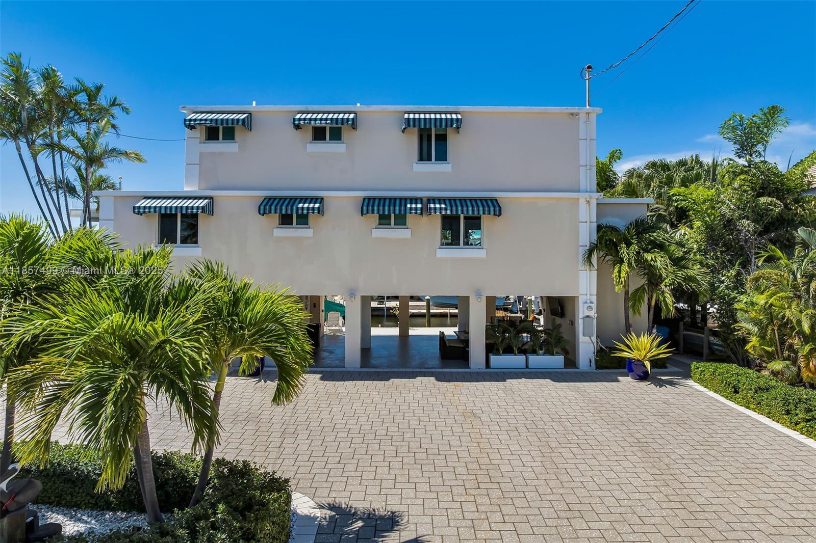 An unparalleled waterfront sanctuary in the prestigious and private beachside of Port Antigua, where luxury meets the laid-back charm of the Florida Keys. This impeccably upgraded home offers the perfect blend of refined coastal living and island serenity — ideal for those seeking an exceptional full-time residence or a serene island escape. 3 Bedroom; 3 Full Bathrooms + extra ½ Bath; Private Dockage + Exclusive Beach Access
1-Car Garage + Ground-Level extra Room; every detail of this home has been thoughtfully designed for comfort and style — from the elegant interiors to the seamless flow of indoor-outdoor living. Outside, enjoy world-class boating with direct access to the bay and ocean. And when you're ready to relax, the private white sand beach is just moments away.
