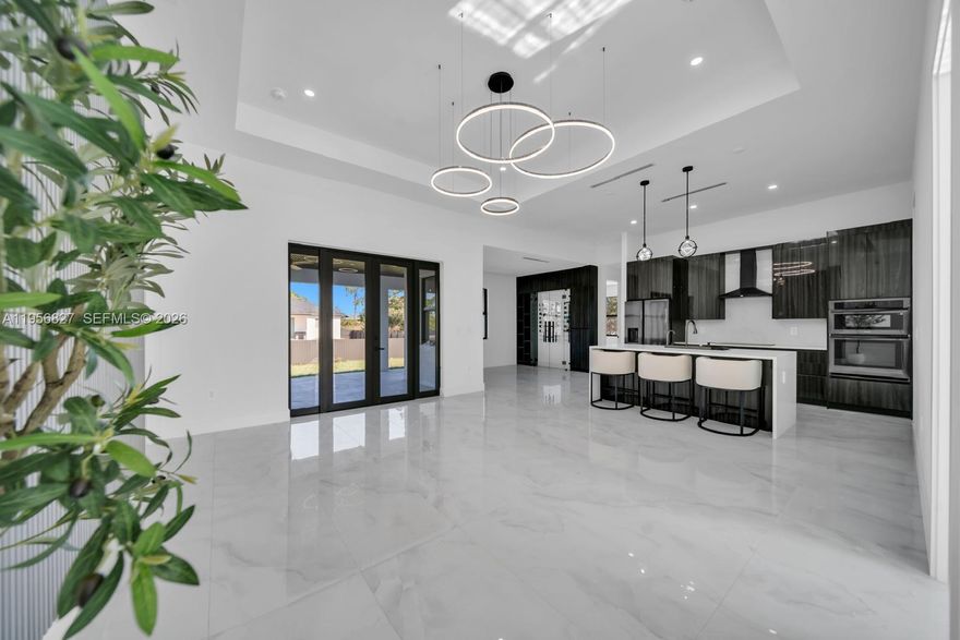 Your Dream Home ! Experience modern Florida luxury in this beautifully designed 4 bedroom, 3 bath offering 1,950 sqft under air and 3000 total sqft. Each bedroom with custom closets and built-in drawers, each bath has Smart Toilets and beautiful finishes!This exceptional home is a open-concept layout with high ceilings, A Dream Modern Kitchen is the master piece, features a waterfall island with quartz countertops and High-quality appliances. You can have you own wine collection because we have creat it ! The primary suite offers a dual walk-in closets. Additional features include impact windows and doors, a full laundry room, epoxy-coated garage floors, an extra large two car garage, a side garage access door and a sprinkler system. Step outside to an expansive covered lanai with outdoor kitchen perfect for entertaining and offering ample space for a future pool. This is definitely your dream house !!!!