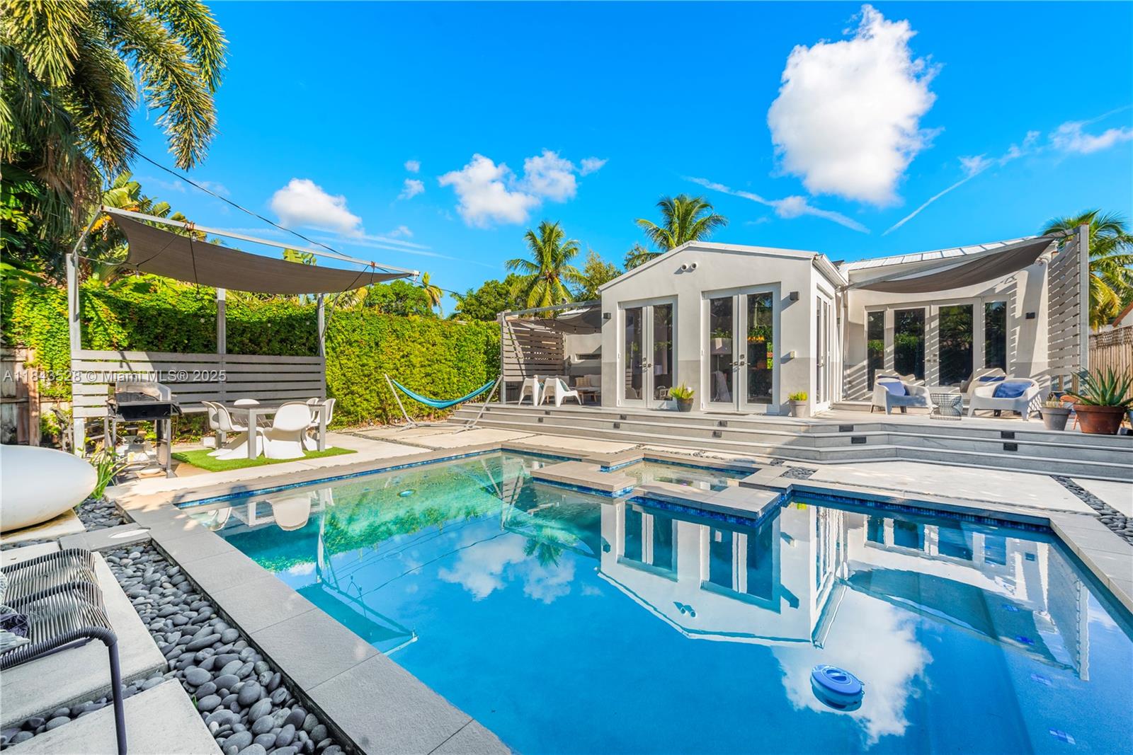 Experience luxury living in a fully remodeled 2-bedroom, 2-bath home in gated Belle Meade, one of Miami’s most stylish neighborhoods. Designed by an interior designer, this home boasts high ceilings, wood floors, a cozy fireplace, and an airy living space that opens to a pool. The elegant kitchen features top-of-the-line appliances and ample storage with a washer and dryer. The spacious principal suite has a private terrace leading to the pool. Enjoy a private oasis backyard with a pool, spa, covered terraces, and BBQ area. Includes an expansive front yard and parking.—move in with just your suitcase.